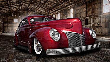 Classic Red Antique Car in an Abandoned Setting wallpaper