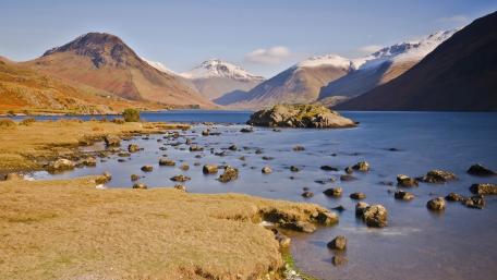 Majestic Lake Surrounded by Mountain Peaks wallpaper