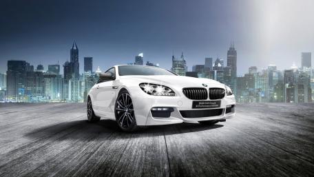 Sleek BMW Coupe Against a City Skyline wallpaper