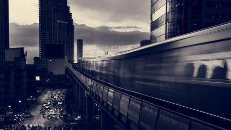 Speeding Subway Amidst City Skyline wallpaper