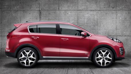 Sleek Kia SUV Against a Modern Background wallpaper
