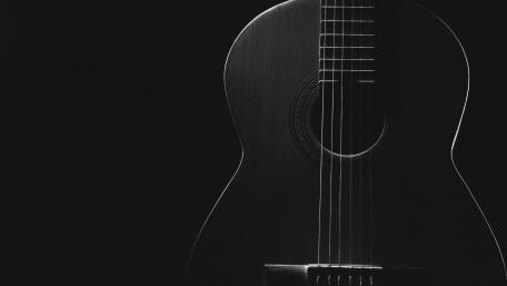 Elegant Acoustic Guitar in Shadows wallpaper