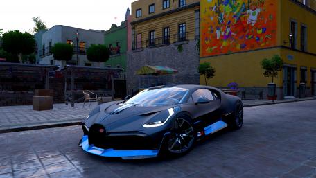 Sleek Hypercar on a Colorful Street wallpaper