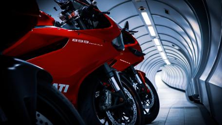 Red Ducati Motorcycles in Futuristic Tunnel Scene wallpaper