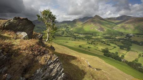 Breathtaking Mountain Landscape with Rolling Green Hills wallpaper
