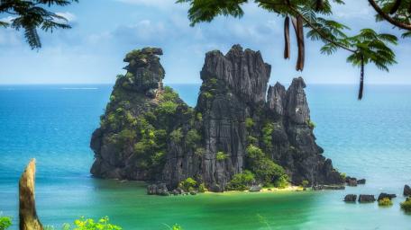Majestic Islet Surrounded by Tranquil Sea Waters wallpaper