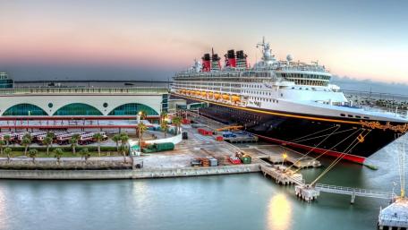 Majestic Ship Docked at Vibrant Port Scene wallpaper