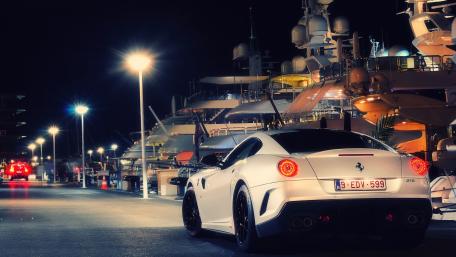 Sleek Ferrari Against a Luxurious Marina Nightscape wallpaper