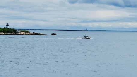 Ocean Serenity with Lighthouse and Boat Scene wallpaper