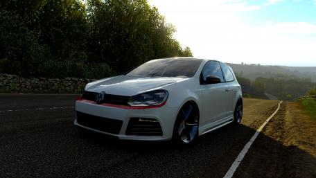 Sleek Volkswagen GTI on a Scenic Roadway wallpaper