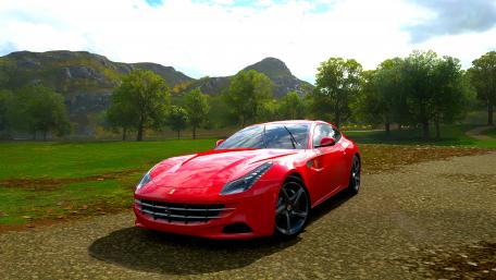 Sleek Red Sports Car on Scenic Landscape wallpaper