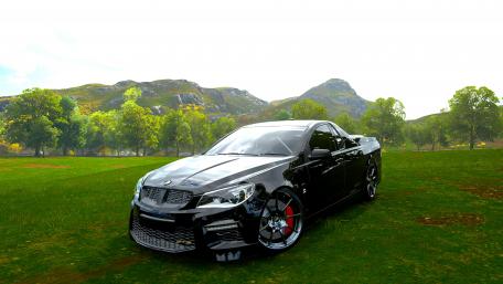 Sleek Black Performance Car in Nature Scene wallpaper