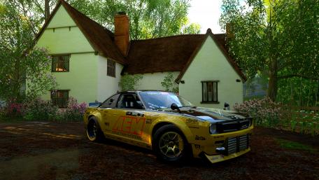 Classic Car in Serene Garden Setting with Vibrant Colors wallpaper