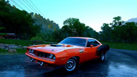 Vibrant Classic Muscle Car Against Serene Landscape wallpaper