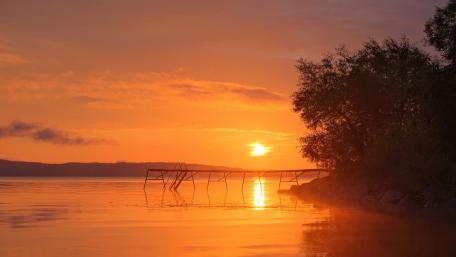 Golden Sunset Over Tranquil Lake Pier wallpaper