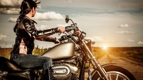 Biker Girl Riding into the Sunset wallpaper