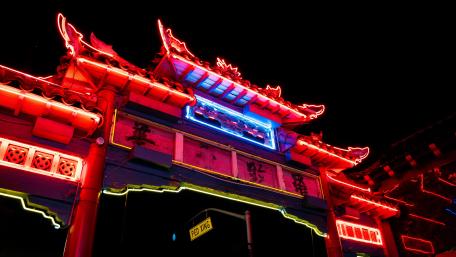 Vibrant Neon Gate Under Night Sky wallpaper