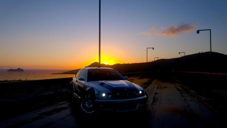 Sleek Car Against a Stunning Sunset View wallpaper