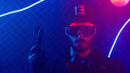 Neon Warrior with Gun in a Futuristic Setting wallpaper