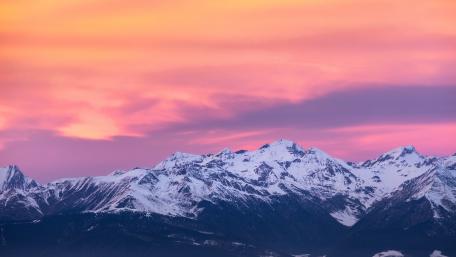 Majestic Mountains Under a Vibrant Pink Sky wallpaper