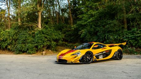 Vibrant McLaren P1 in Nature's Embrace wallpaper