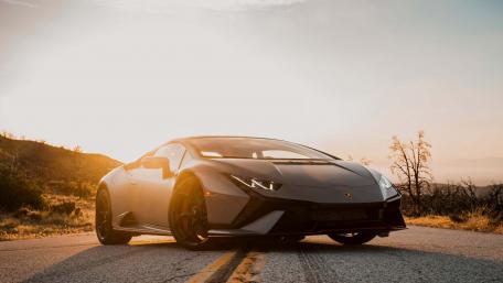 Sleek Sunset Drive with Lamborghini Huracan Tecnica wallpaper