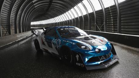 Sporty Alpine A110 Racing in Dynamic Tunnel Setting wallpaper