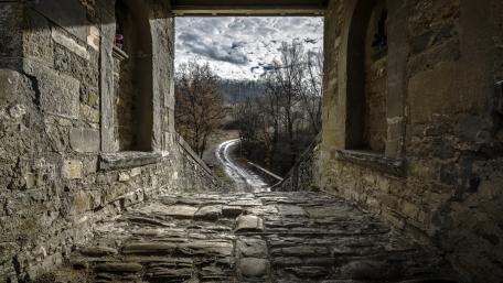 Ancient Pathway Through Weathered Stone Walls wallpaper