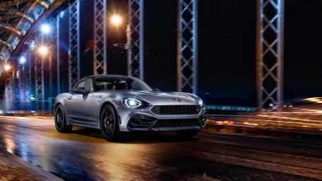 Sleek Fiat 124 Abarth at Night Under Lights wallpaper