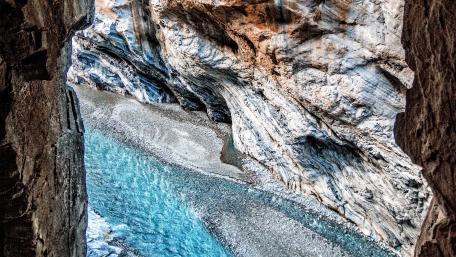 Majestic Stream Flowing Through Rocky Canyon View wallpaper