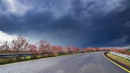 Curving Road Under Ominous Skies wallpaper
