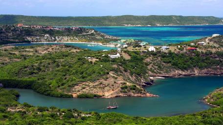 Scenic Coastal Landscape with Vibrant Waters and Lush Greenery wallpaper