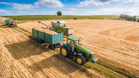 Harvesting Fields with Modern Tractors in Action wallpaper