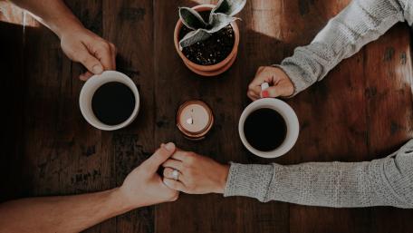 Holding hands during morning coffee wallpaper