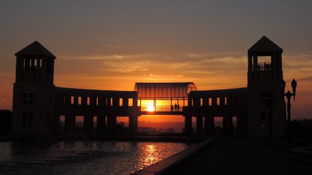 Golden Sunset Over City Architecture and Silhouettes wallpaper