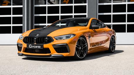 Stunning BMW M8 in Bold Orange Design for Enthusiasts wallpaper