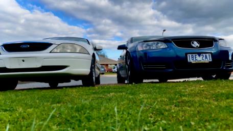 Classic Cars Side by Side on Grass wallpaper