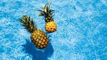Pineapples Floating in Crystal Blue Water wallpaper