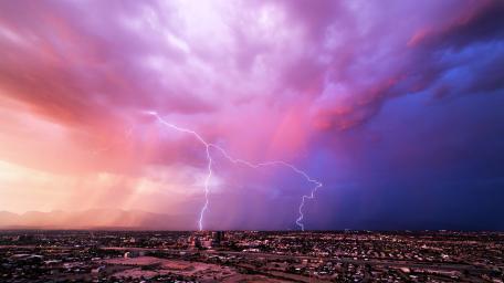 Pink Lightning Over Cityscape wallpaper