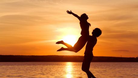 Embrace of Love Under a Sunset Sky wallpaper