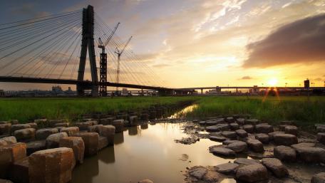 Serene Sunset Over the Bridge in Nature's Embrace wallpaper