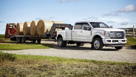 Powerful Ford F-450 Hauling Bales in Rural Landscape wallpaper