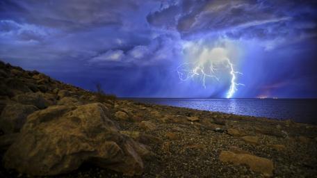 Majestic Thunderstorm Over Waterway wallpaper