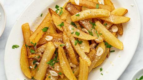 Golden Crispy French Fries with Garlic and Parsley wallpaper