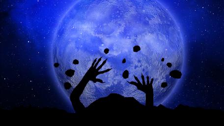 Chilling Zombie Hands Against a Full Moon Scene wallpaper