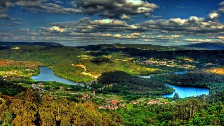 Scenic River Landscape Under Dramatic Clouds wallpaper