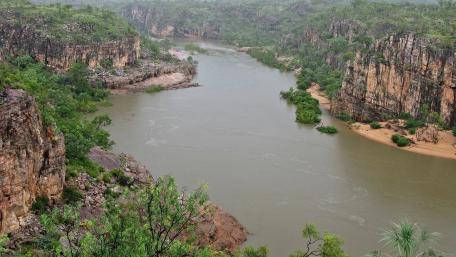 Serene River Winding Through Majestic Cliffs wallpaper