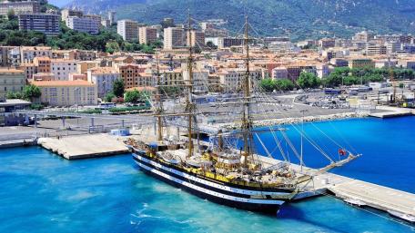 Majestic Schooner Docked in Vibrant Harbor Scene wallpaper