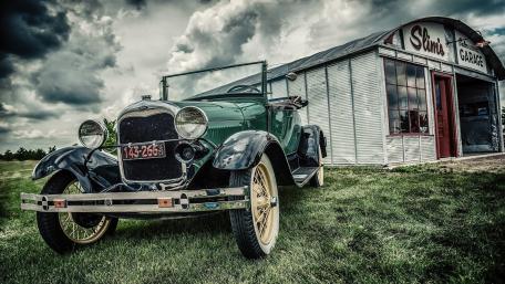 Classic Vintage Ford Car at a Quaint Garage Scene wallpaper