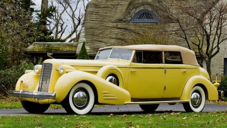 Classic Yellow Vintage Car in a Scenic Setting wallpaper